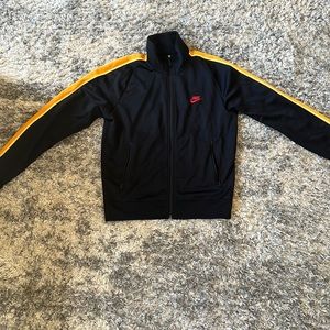 Nike size S sweatsuit top black with yellow stripe on the sides.
